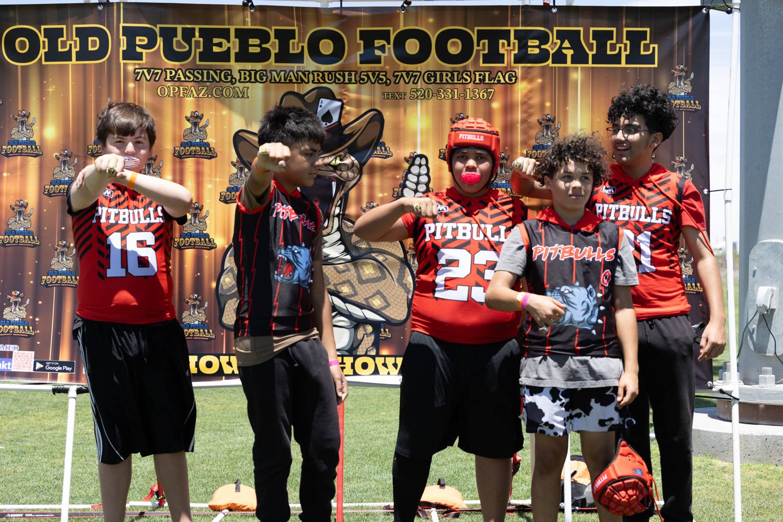 A team posing in front of the Old Pueblo Football banner at Kino